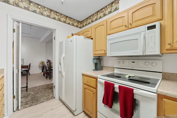 a kitchen with stainless steel appliances granite countertop a stove a refrigerator and a cabinets