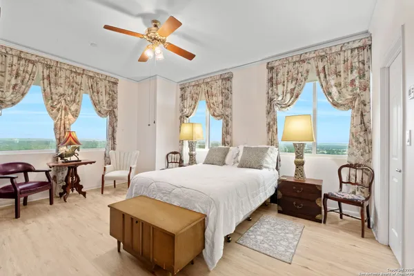 a bedroom with a bed and a chandelier