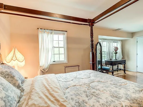 a bedroom with a bed table and chair