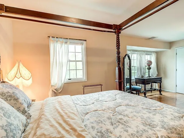 a bedroom with a bed table and chair