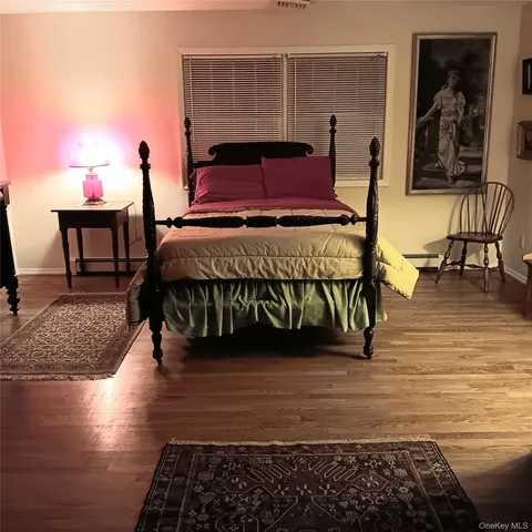a bed sitting in a bedroom next to a lamp