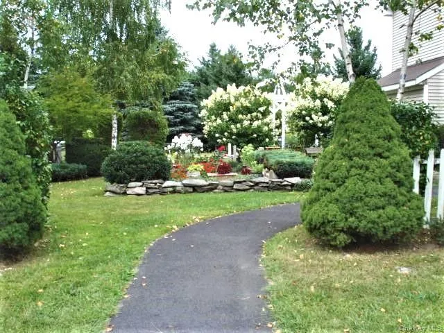 a view of a garden with large trees