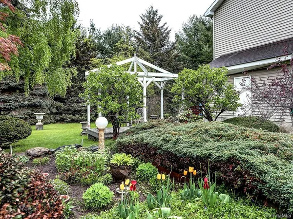 a backyard of a house with table and chairs
