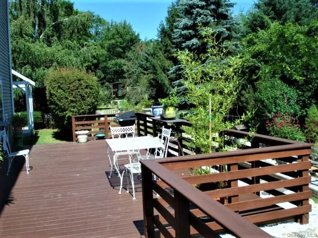a view of a chairs and table on the wooden deck