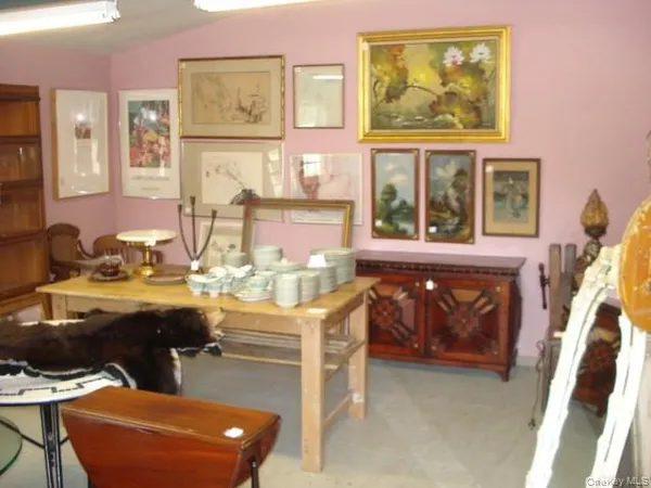 a room with table chairs and wooden floor