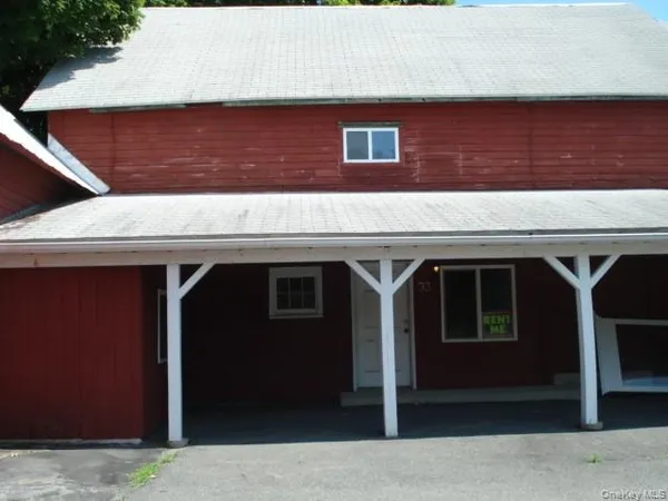 a front view of a house with parking space