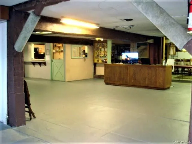 a view of living room with kitchen island stainless steel appliances wooden floor and view living room