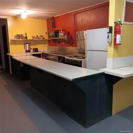 a kitchen with a refrigerator and a more cabinets