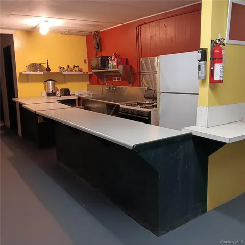 a kitchen with a refrigerator and a more cabinets
