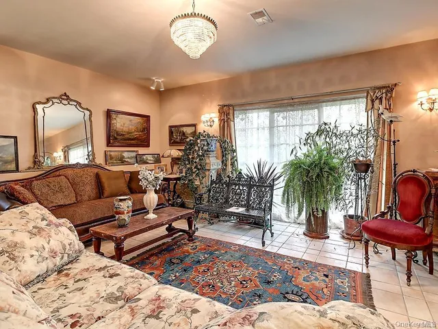a living room with furniture a rug and a large window