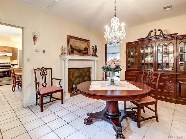 a view of a dining room with furniture a chandelier and wooden floor