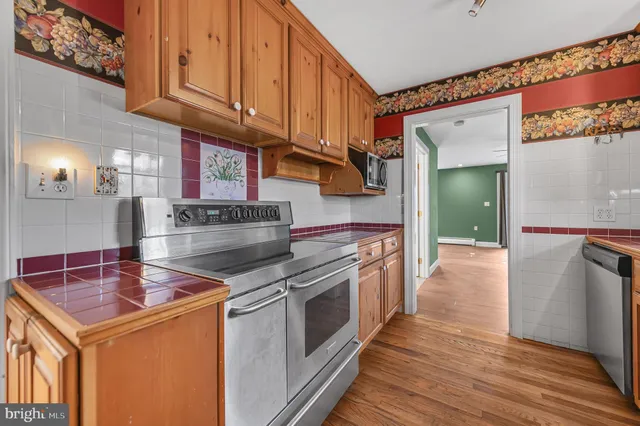 a kitchen with stainless steel appliances granite countertop a stove and a refrigerator