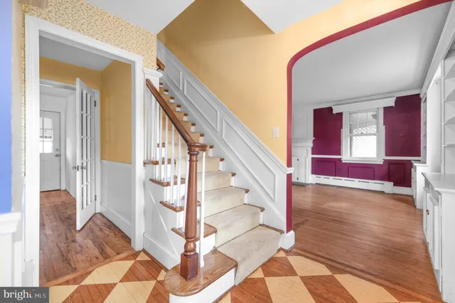 a view of entryway and hall with wooden floor