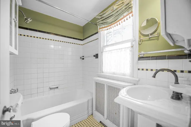 a bathroom with a sink a toilet and bathtub