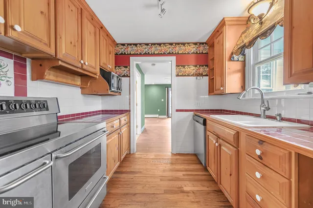 a kitchen with stainless steel appliances a stove and cabinets