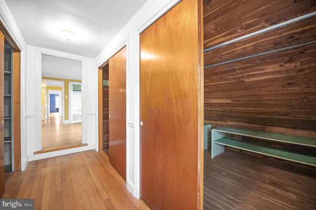 a view of a hallway with wooden floor and entryway