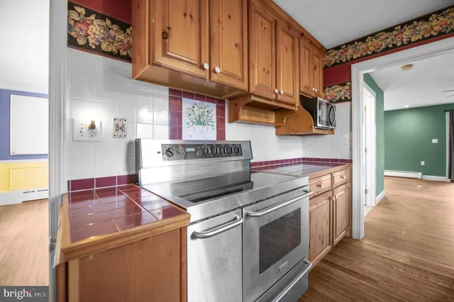 a kitchen with stainless steel appliances granite countertop a stove and a sink