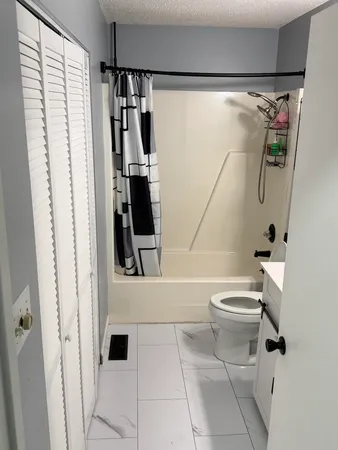 a bathroom with a toilet and a shower