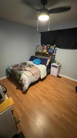 a bedroom with two bed and a chandelier