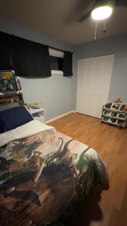 a bedroom with a bed and a television