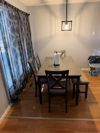 a view of a room with furniture and wooden floor