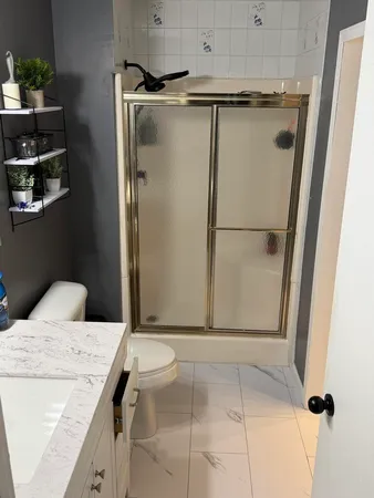 a bathroom with a shower and a sink