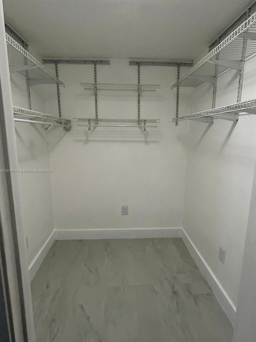 1750 Northeast 191st Street, Unit 4264 Miami, FL 33179 - Photo 14 of 21 a view of a room with racks on the wall