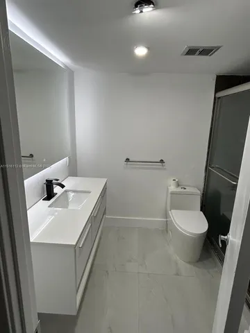 a bathroom with a shower and toilet
