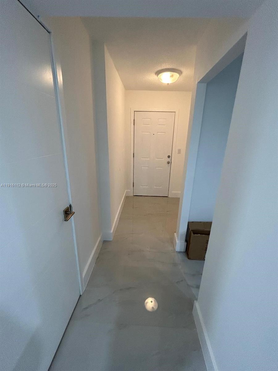1750 Northeast 191st Street, Unit 4264 Miami, FL 33179 - Photo 6 of 21 an empty room with wooden floor