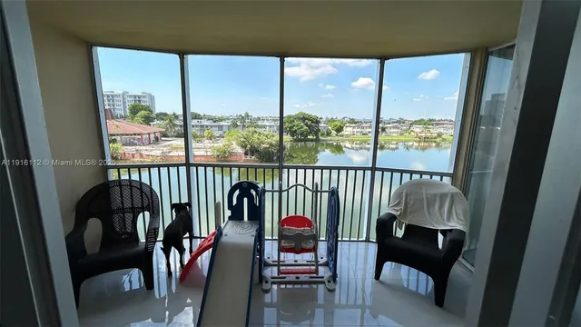a balcony with furniture and a potted plant