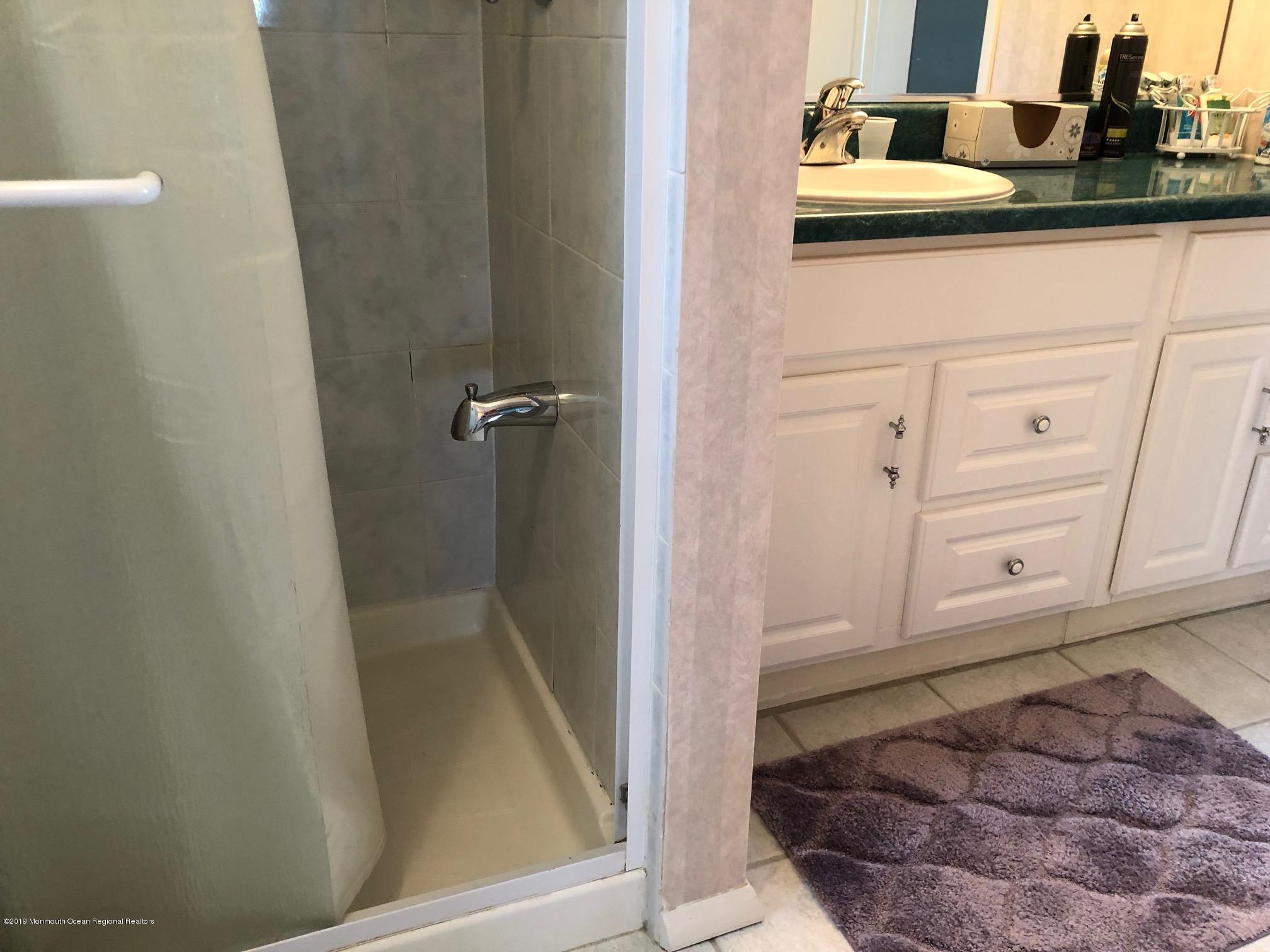 15 Robinson Road Brick, NJ 08724 - Photo 14 of 24 a bathroom with a sink and mirror