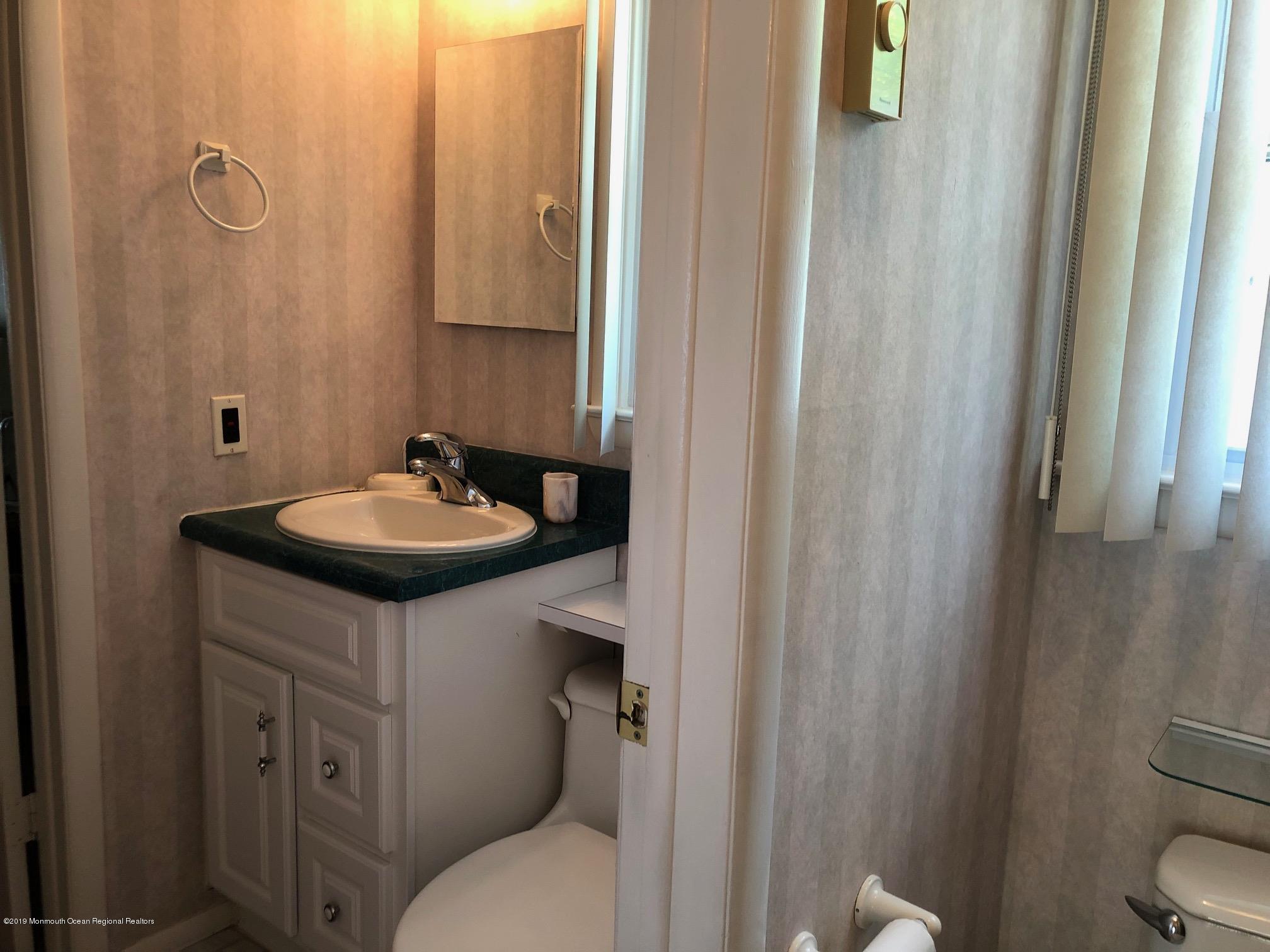 15 Robinson Road Brick, NJ 08724 - Photo 15 of 24 a bathroom with a sink and a mirror