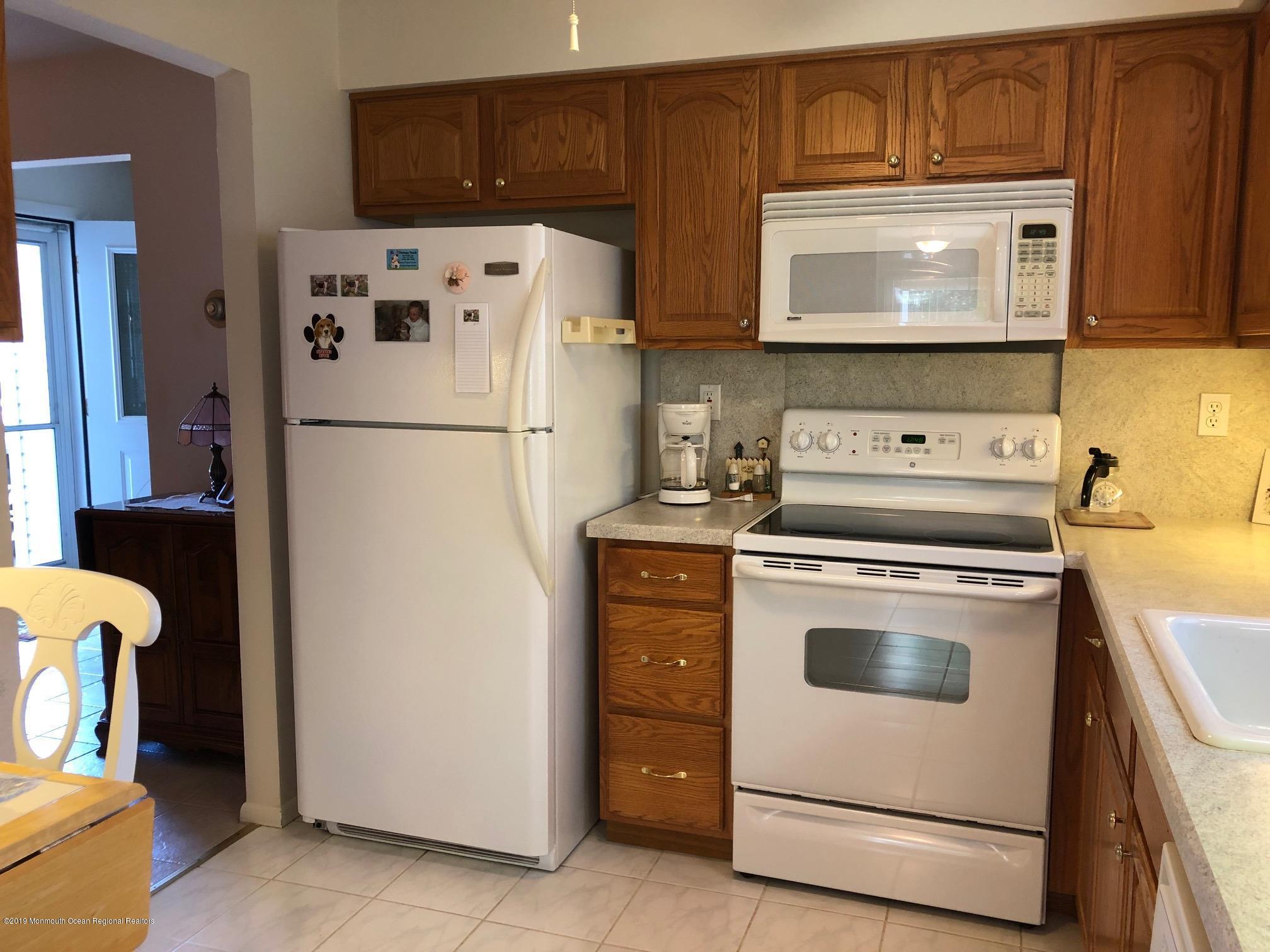 15 Robinson Road Brick, NJ 08724 - Photo 7 of 24 a white refrigerator freezer sitting in a kitchen