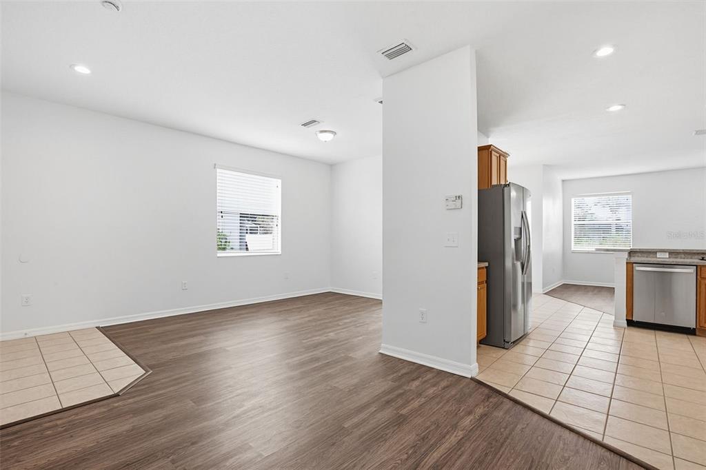 7702 Dragon Fly Loop Gibsonton, FL 33534 - Photo 11 of 42 an empty room with wooden floor and windows