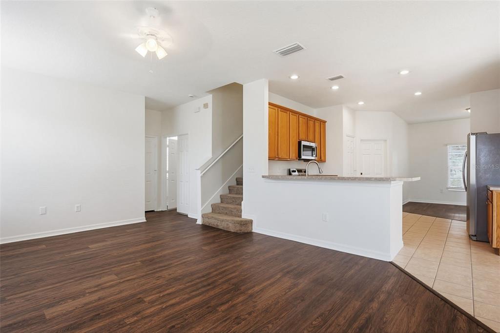 7702 Dragon Fly Loop Gibsonton, FL 33534 - Photo 12 of 42 a view of kitchen with cabinets and wooden floor