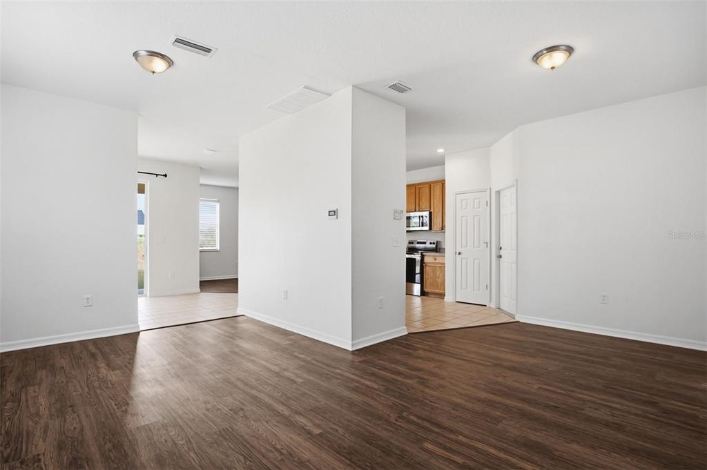 7702 Dragon Fly Loop Gibsonton, FL 33534 - Photo 16 of 42 a view of an empty room with wooden floor