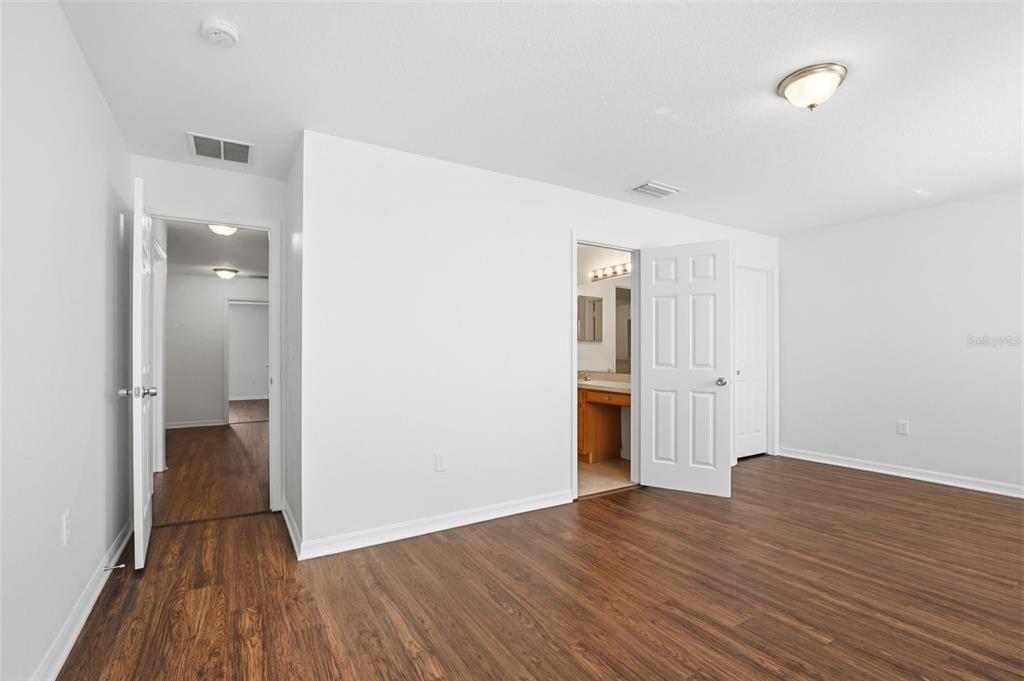 7702 Dragon Fly Loop Gibsonton, FL 33534 - Photo 20 of 42 a view of a hallway with wooden floor