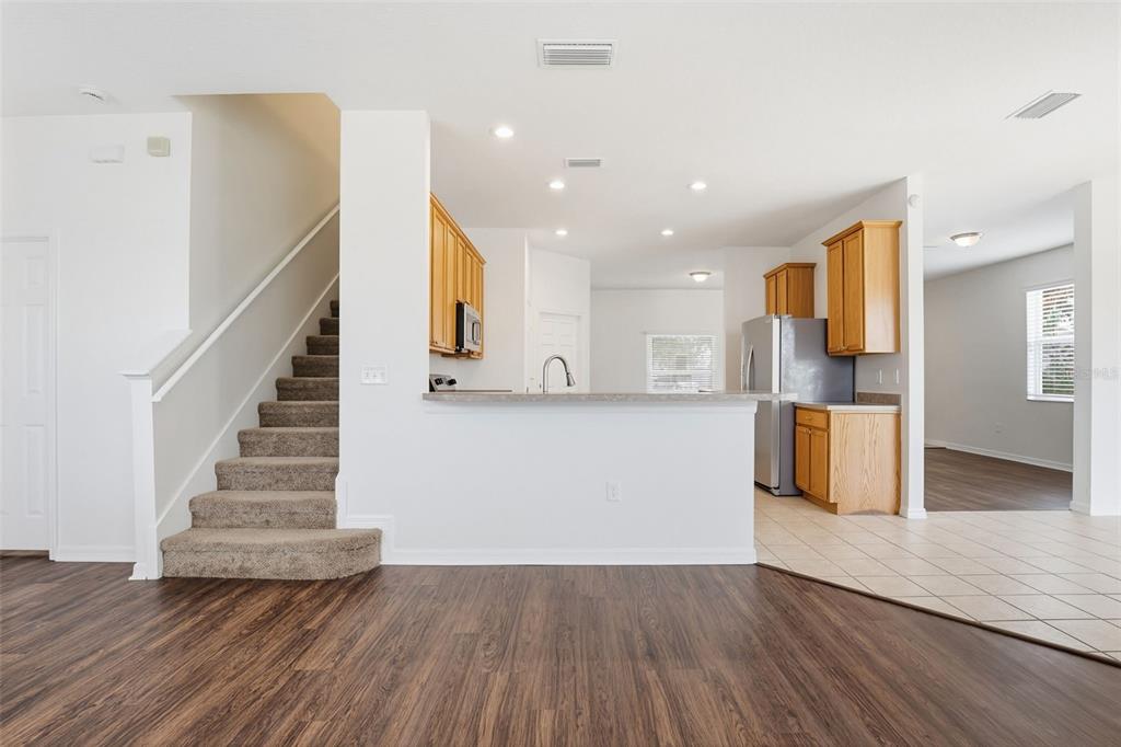 7702 Dragon Fly Loop Gibsonton, FL 33534 - Photo 21 of 42 a view of a kitchen with wooden floor and stairs