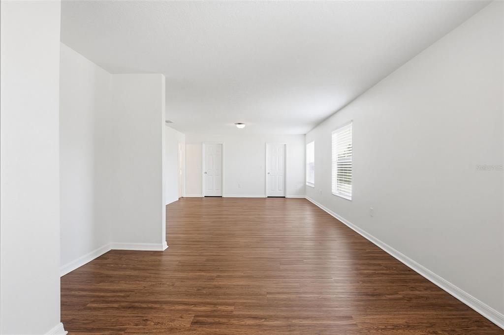 7702 Dragon Fly Loop Gibsonton, FL 33534 - Photo 22 of 42 a view of an empty room with wooden floor and a window