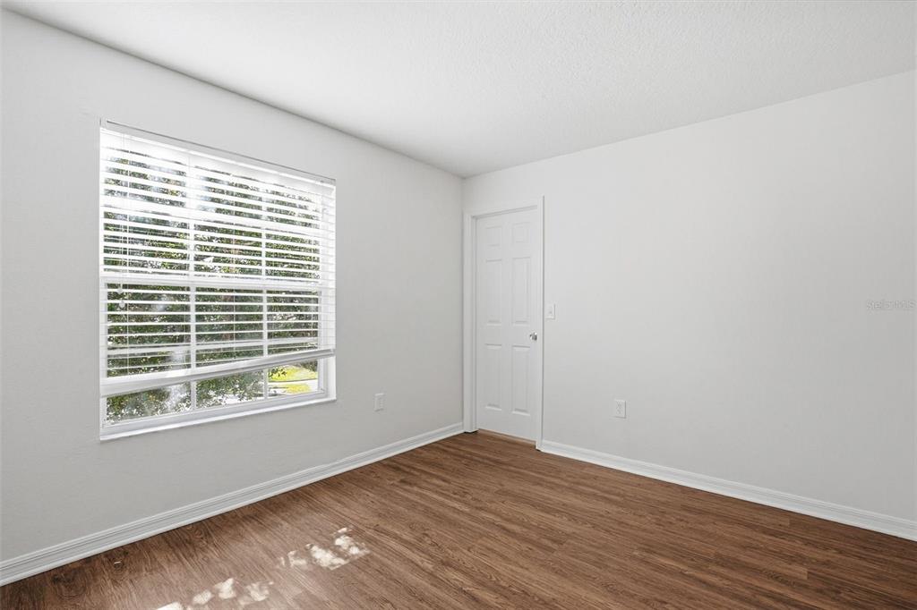 7702 Dragon Fly Loop Gibsonton, FL 33534 - Photo 27 of 42 a view of an empty room with wooden floor and a window