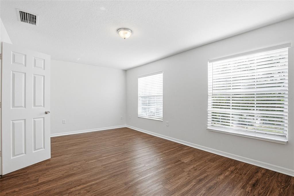 7702 Dragon Fly Loop Gibsonton, FL 33534 - Photo 30 of 42 a view of an empty room with wooden floor and a window