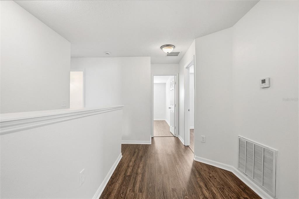 7702 Dragon Fly Loop Gibsonton, FL 33534 - Photo 10 of 42 a view of a hallway with wooden floor
