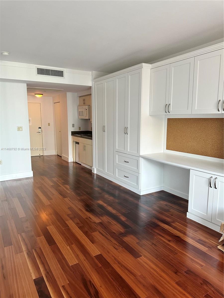 2889 McFarlane Road, Unit 903 Miami, FL 33133 - Photo 3 of 10 a view of empty room with wooden floor