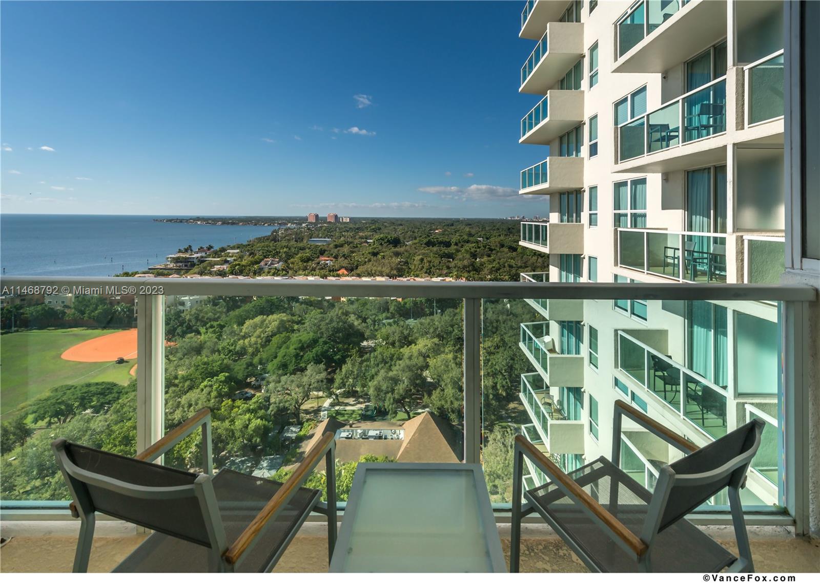 2889 McFarlane Road, Unit 903 Miami, FL 33133 - Photo 7 of 10 a view of a chairs and table in a balcony