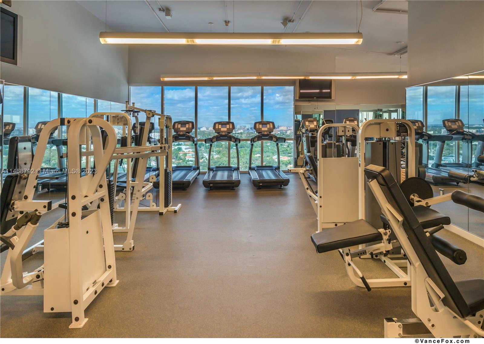 2889 McFarlane Road, Unit 903 Miami, FL 33133 - Photo 8 of 10 a view of a room with gym equipment