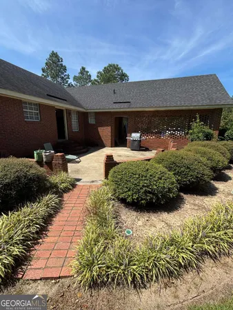 a front view of house with yard and outdoor seating