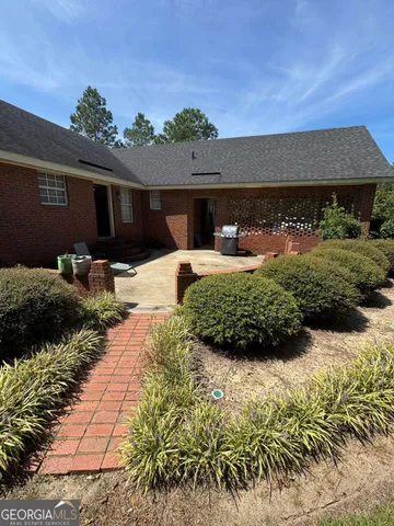a front view of house with yard and outdoor seating