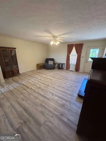 a large room with wooden floor and windows