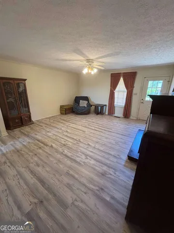 a large room with wooden floor and windows