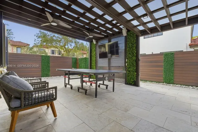 a view of a porch with furniture and a yard